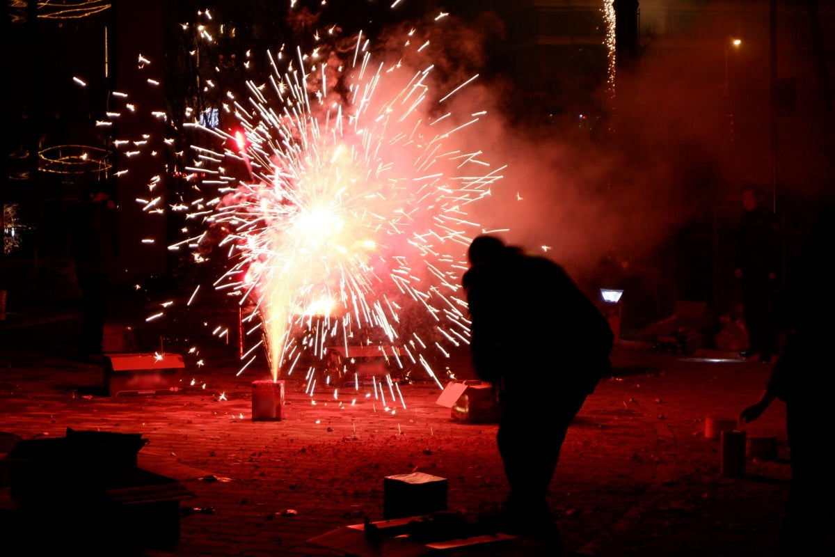 Bright ground fireworks display at night showcasing creative firework stand ideas for attracting customers during holiday events
