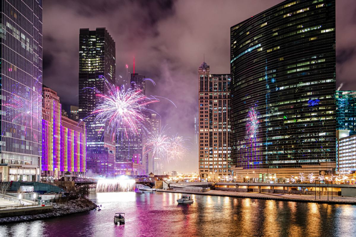 Fireworks over a city skyline at night, showing what holidays have fireworks in major urban celebrations